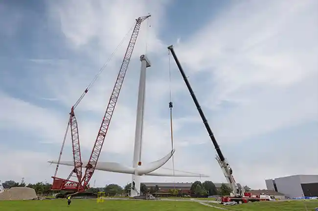 Two Cranes Lifting a wind turbine